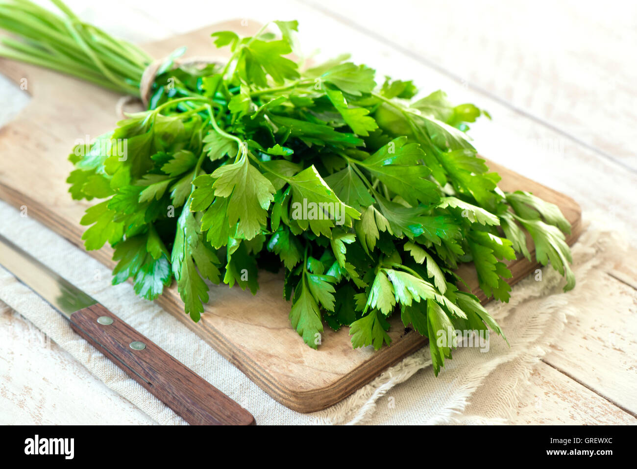 Organic italian parsley closeup on rustic wooden table, healthy vegetarian food Stock Photo