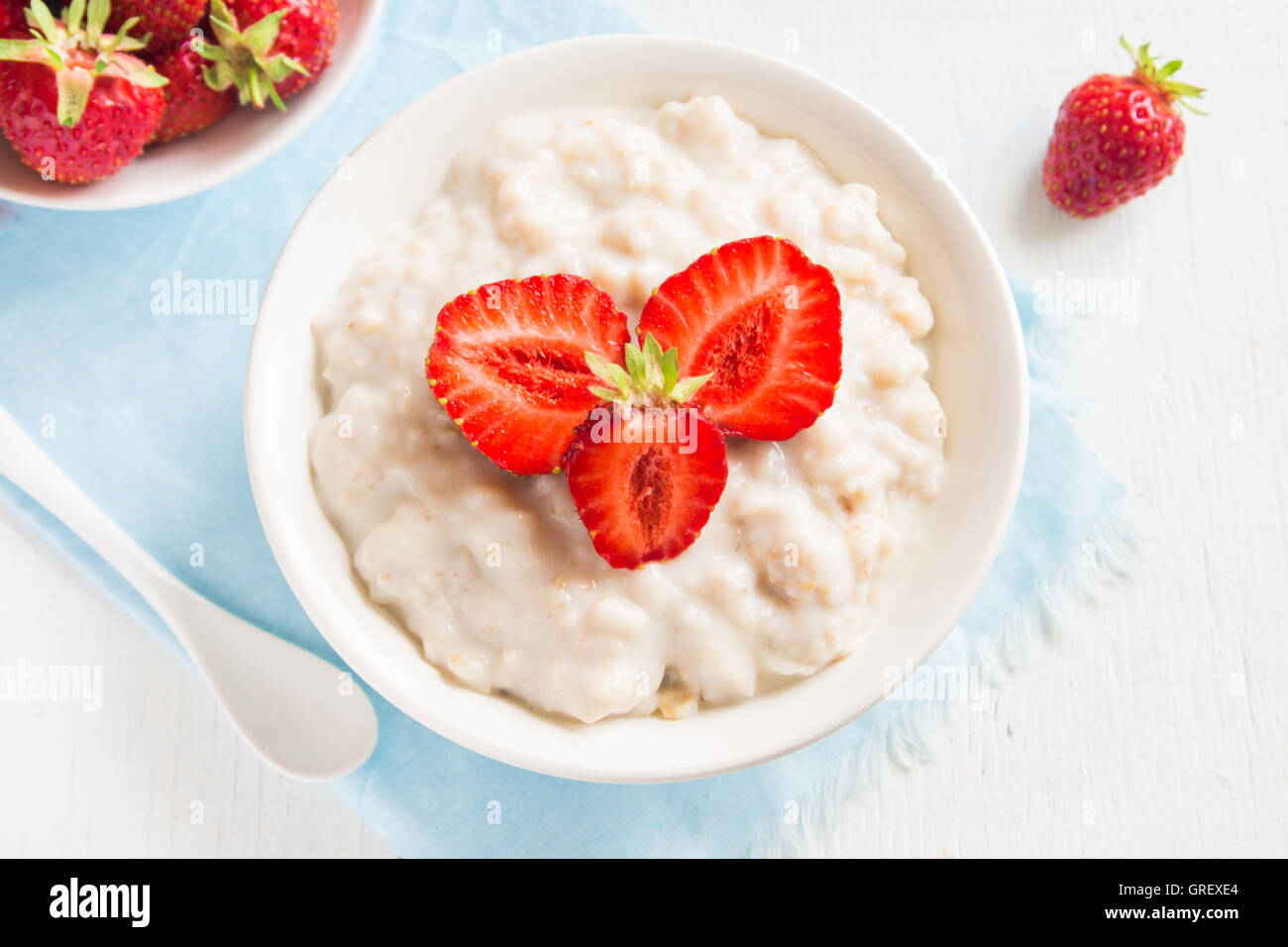 Oatmeal porridge with strawberries in bowl for healthy breakfast Stock Photo