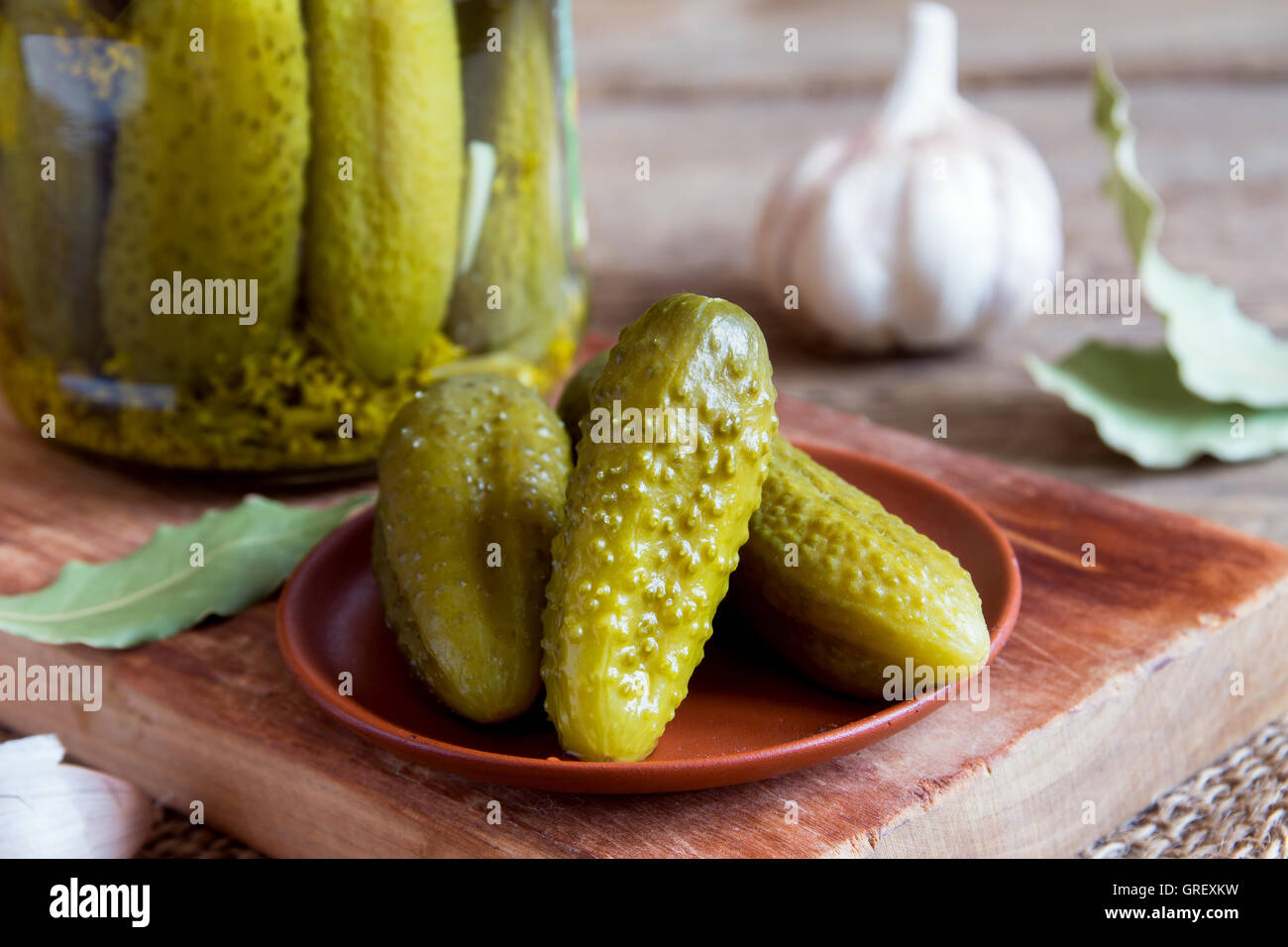 Homemade pickles on ceramic plate over rustic wooden background Stock