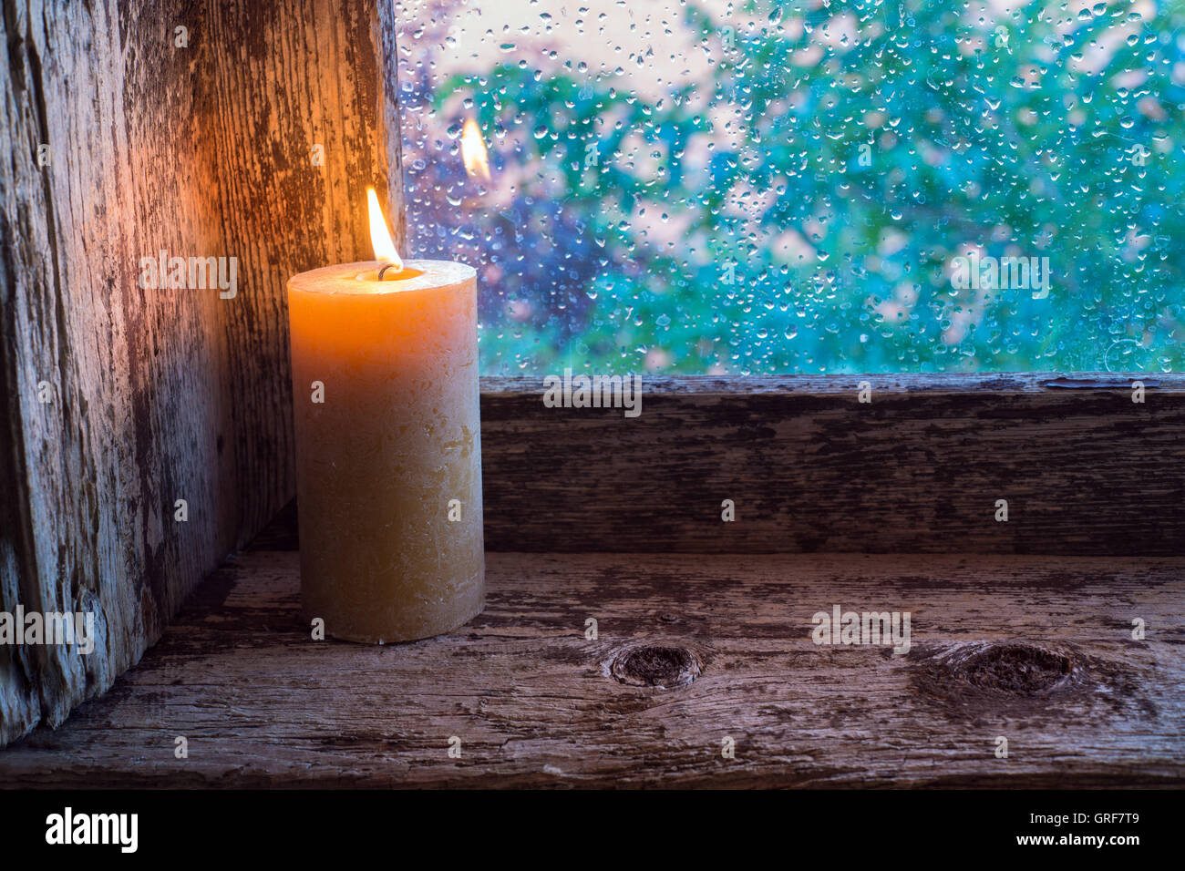 Burning candle on the sill of a window. Christmas ornament Stock Photo