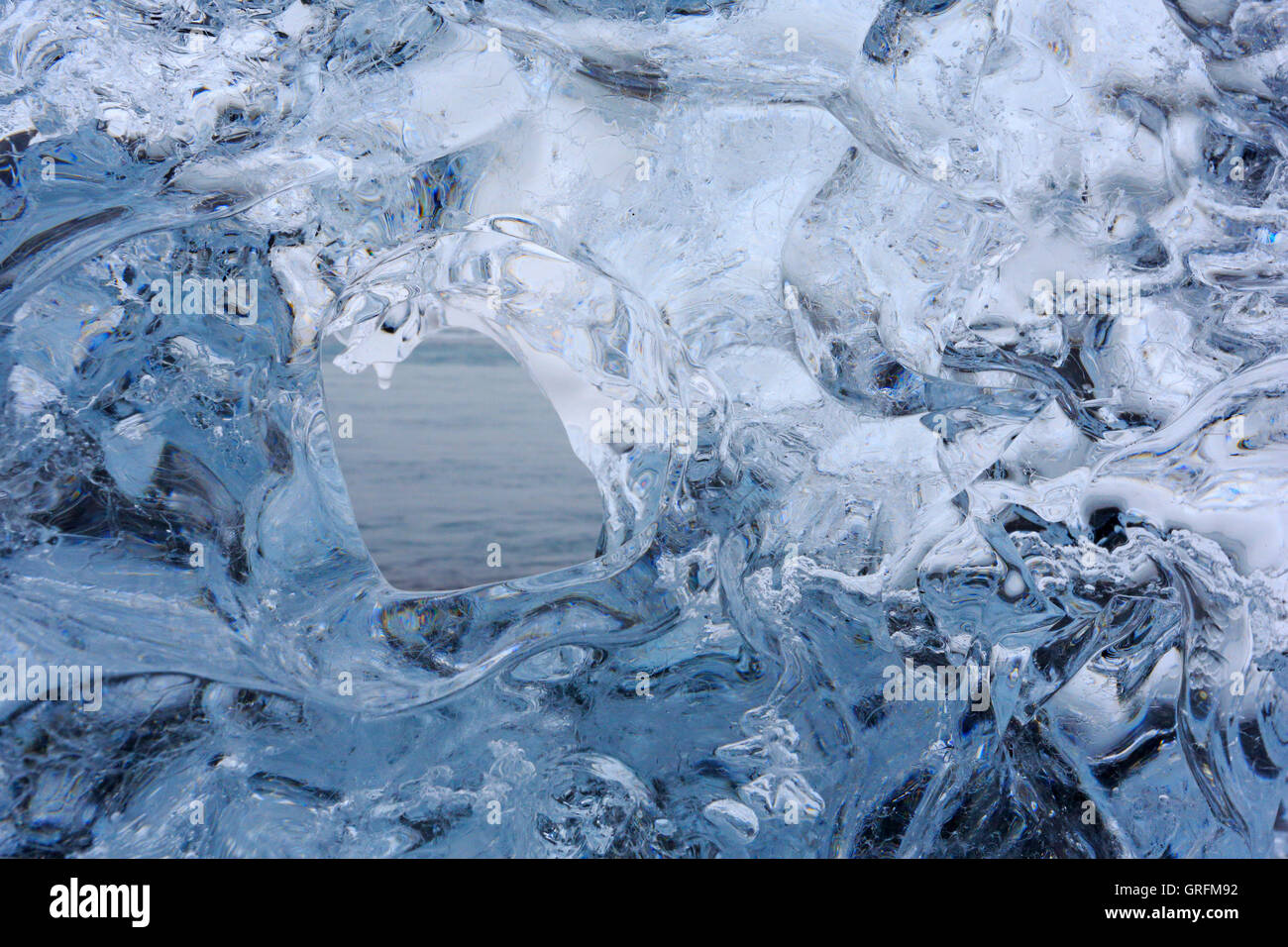 Tunnel through an ice block at the glacier lagoon in Iceland Stock ...