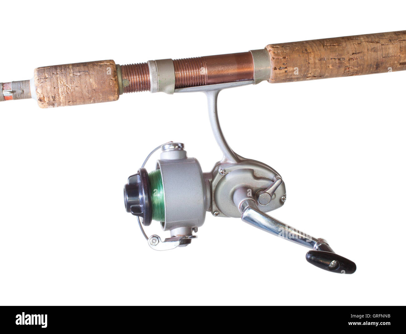Old spinning reel with green fishing line and a rod isolated on white Stock Photo