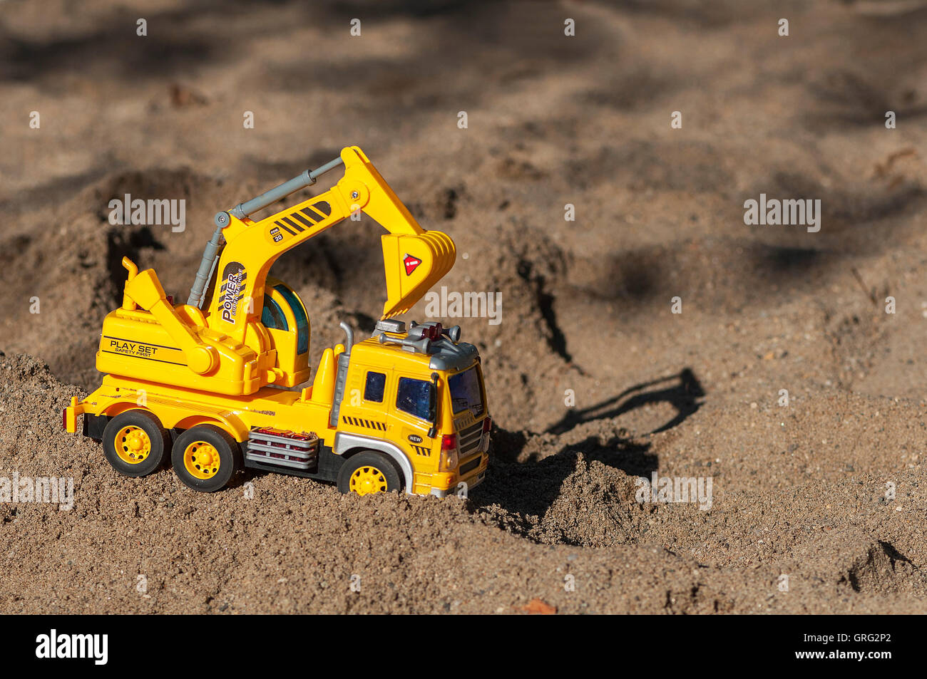 Toy excavator in the sand. Children's toy Stock Photo Alamy