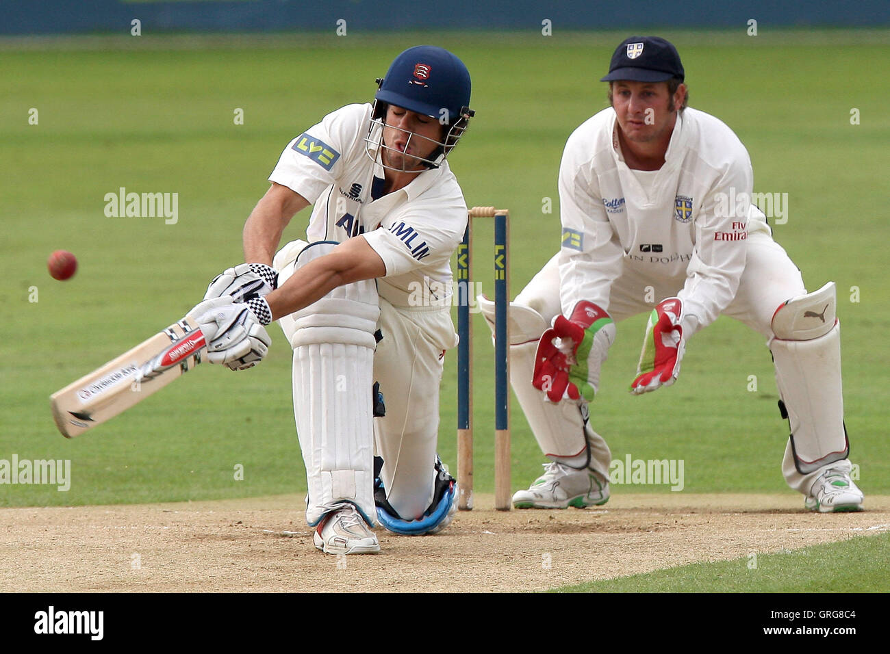 Phil Mustard of Durham looks on as Alastair Cook plays the sweep shot
