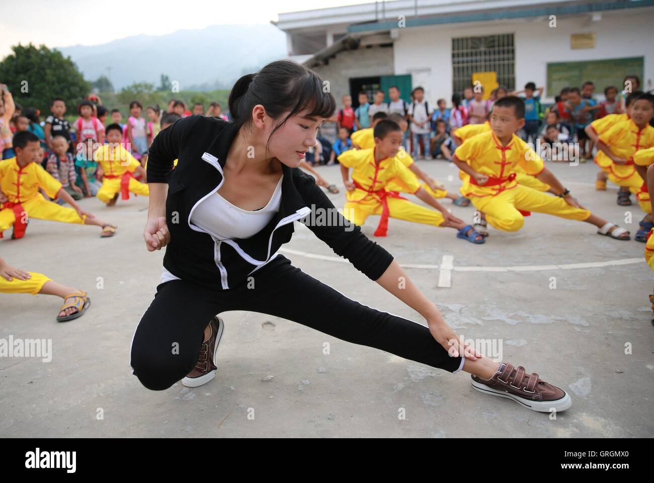 Liuzhou. 7th Sep, 2016. Wu Zhongyan (Front), a rural primary school teacher, teaches her students martial arts in Gaoma Village Primary School, where most students are 'left-behind children', in Liuzhou, south China's Guangxi Zhuang Autonomous Region. The phrase is used in China to describe rural children whose parents work in other cities. Left-behind children usually live with relatives, often their grandparents, while their parents work away from home. © Long Tao/Xinhua/Alamy Live News Stock Photo