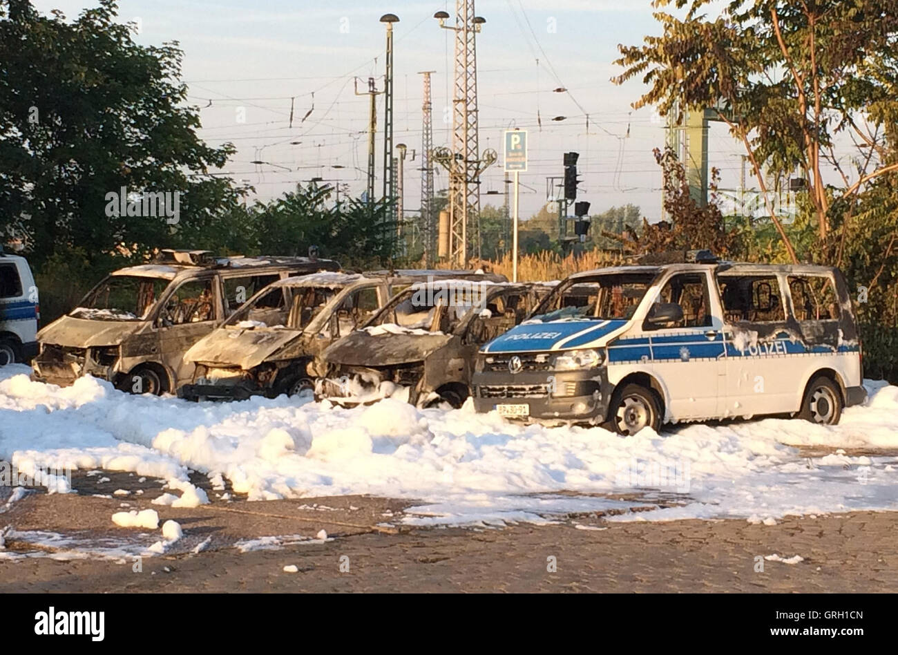 Magdeburg, Germany. 8th Sep, 2016. Several burned down cars, including cars of the federal police and Deutsche Bahn, can be seen at the central station in Magdeburg, Germany, 8 September 2016. 18 cars were burning during Wednesday night on the grounds of the federal police. The police suspects an arson attack. PHOTO: PETER GERCKE/dpa/Alamy Live News Stock Photo
