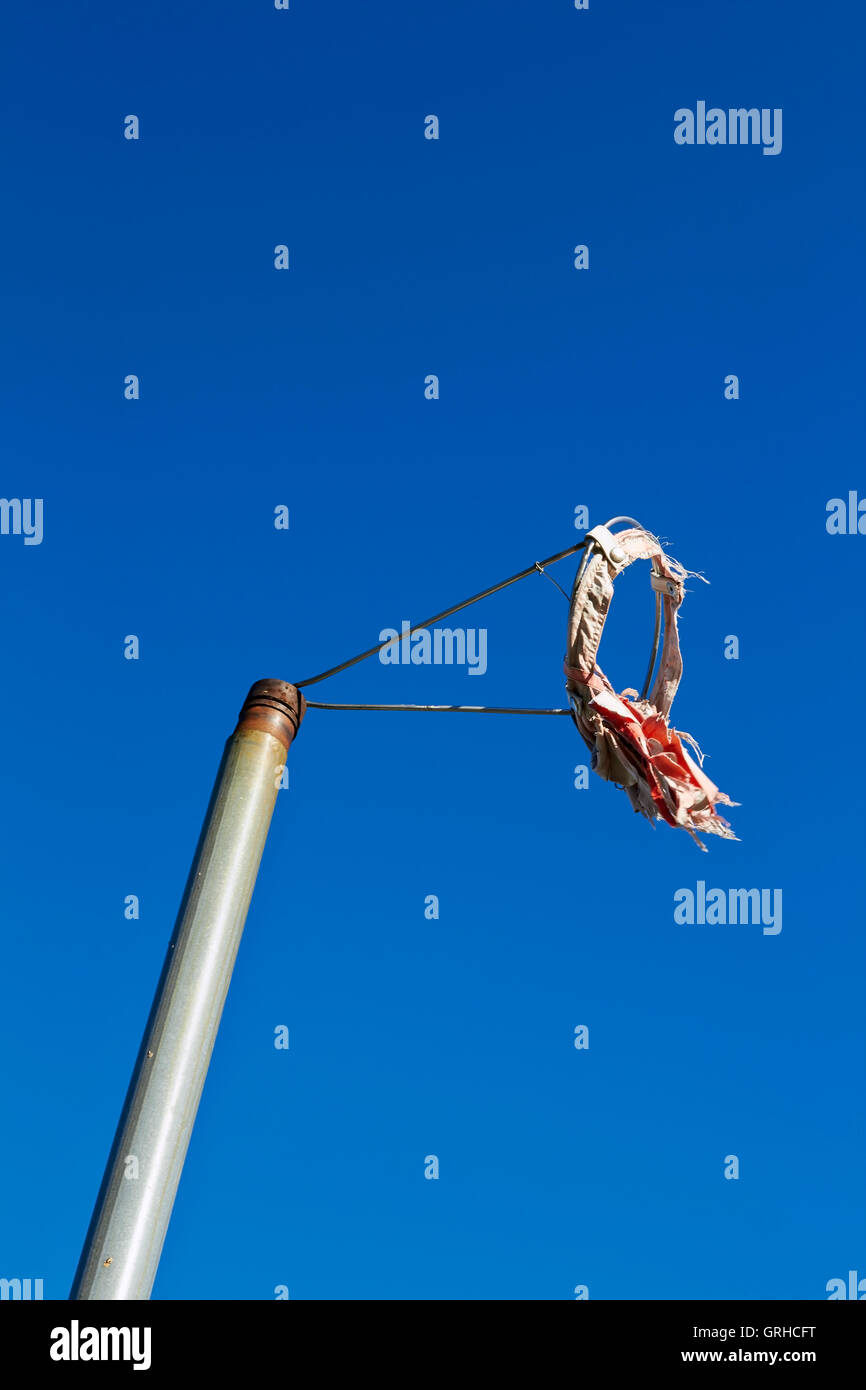 worn out windsock against blue sky Stock Photo