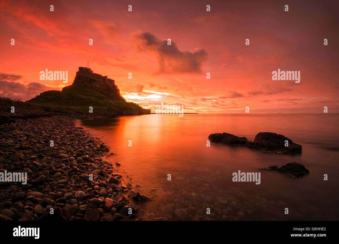 Golden sunrise at Lindisfarne Castle on Holy Island, Northumberland England UK Stock Photo