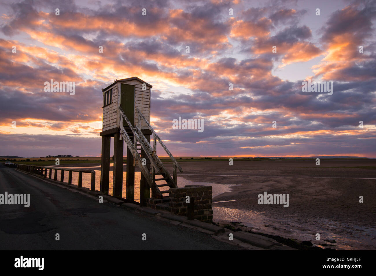 Sunset at the emergency watch tower on Holy Island, Northumberland England UK Stock Photo