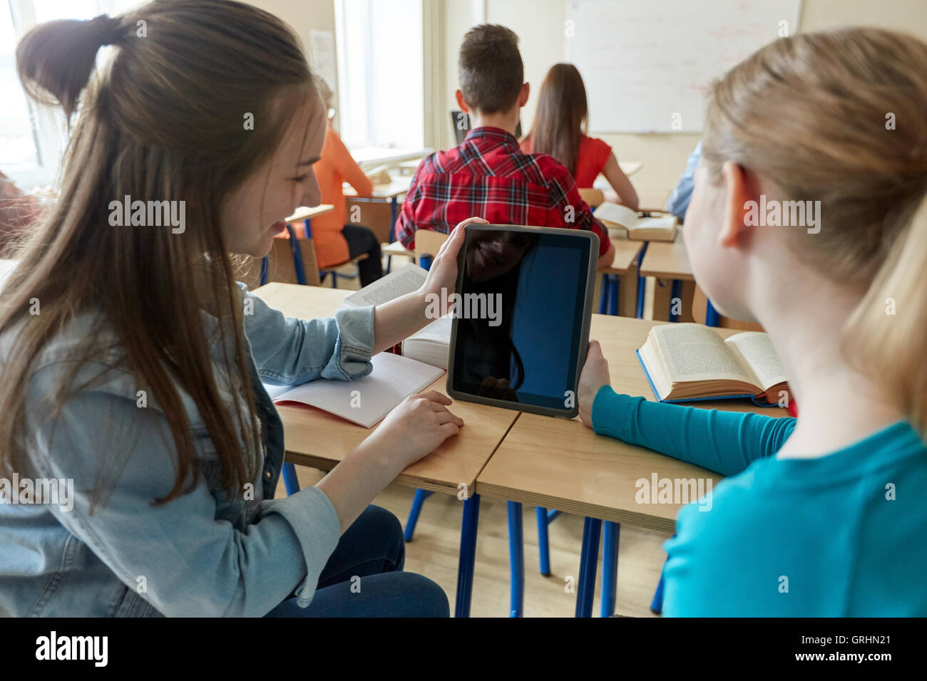 happy student girls with tablet pc at high school Stock Photo - Alamy
