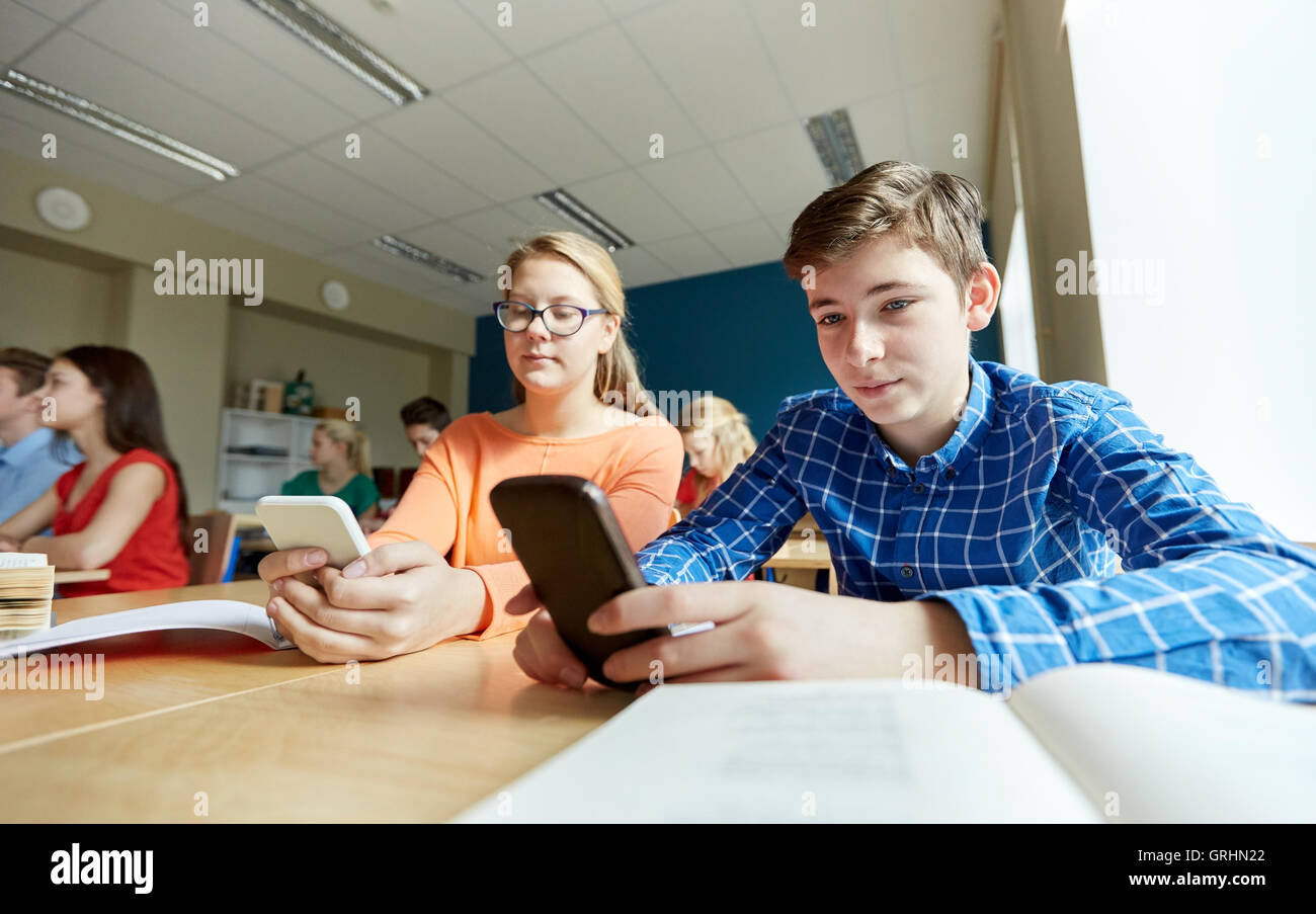students with smartphone texting at school Stock Photo Alamy