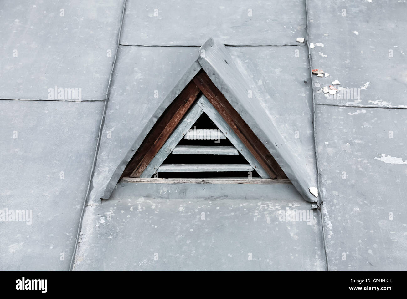 Triangle ventilation window in metal roof. Closeup photo Stock Photo