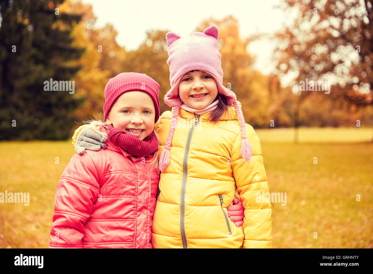 two happy little girls hugging in autumn park Stock Photo - Alamy