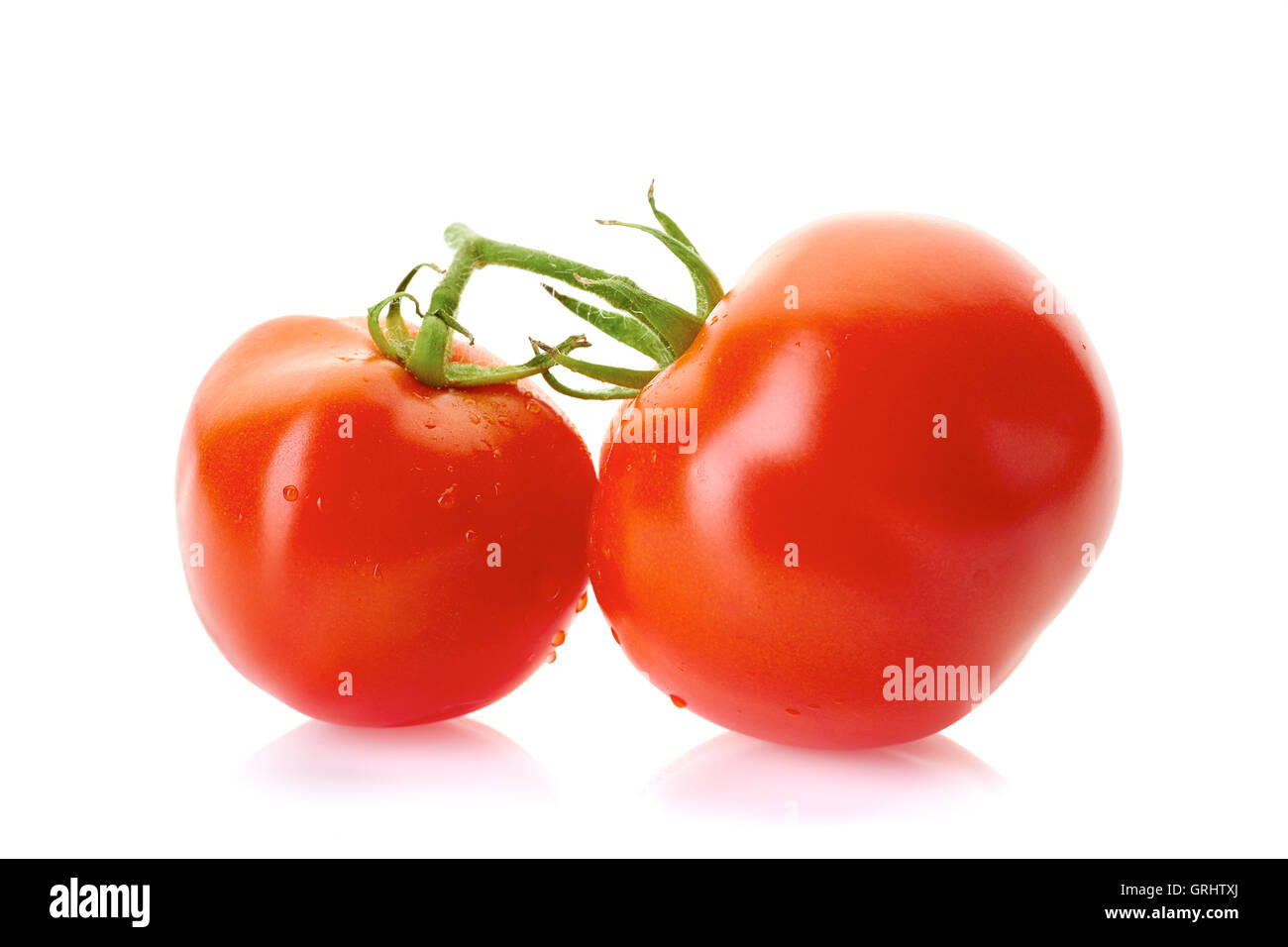 Bunch of two tomatoes with water drops on white Stock Photo