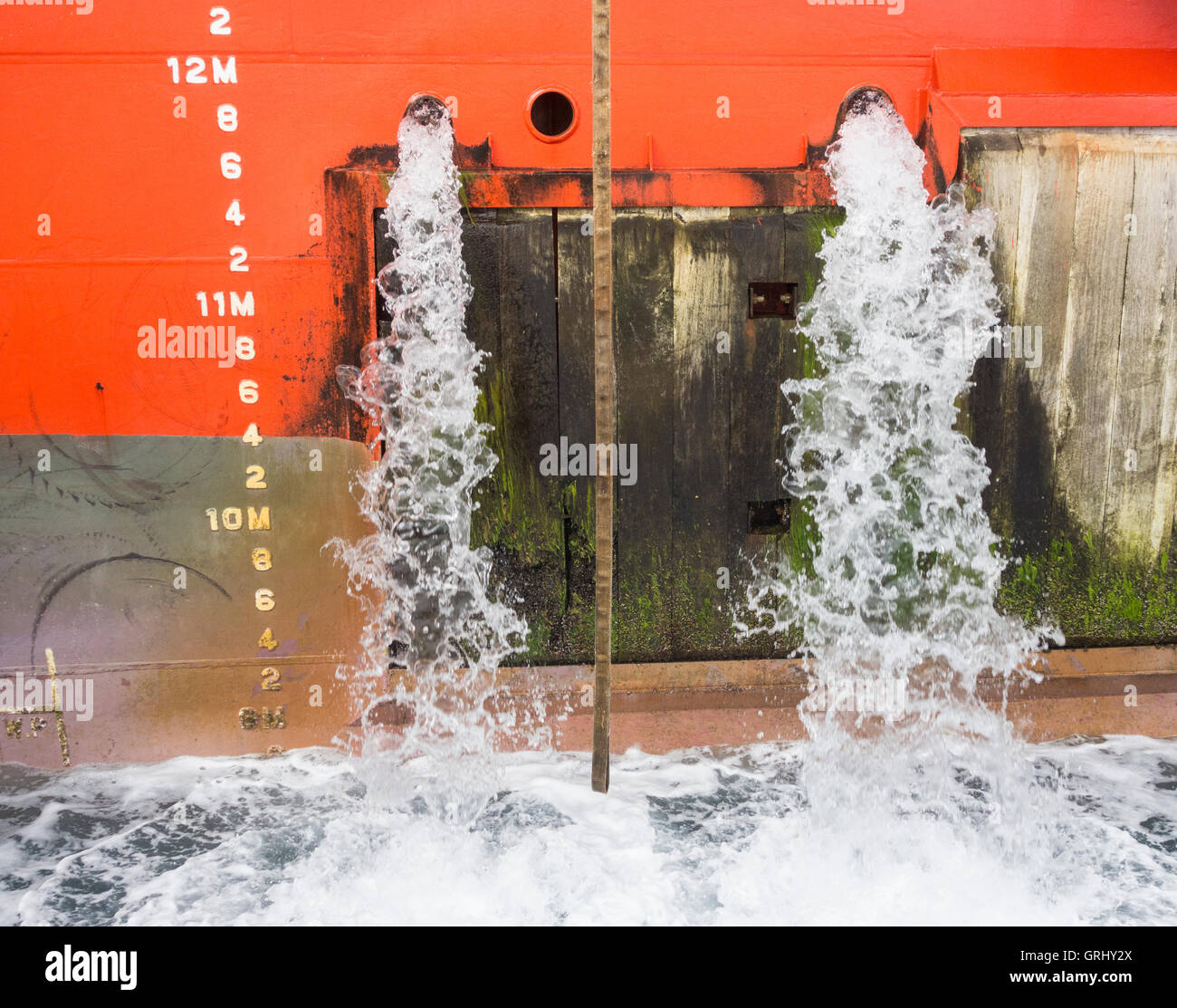 Large ship emptying ballast water in port Stock Photo Alamy