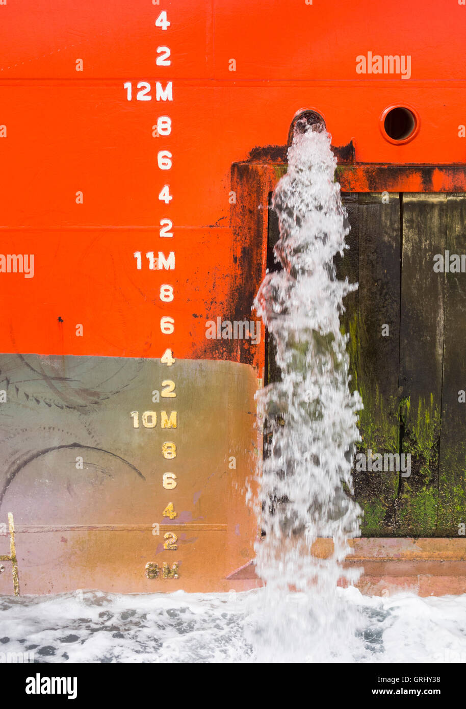 Large ship emptying ballast water in port Stock Photo Alamy