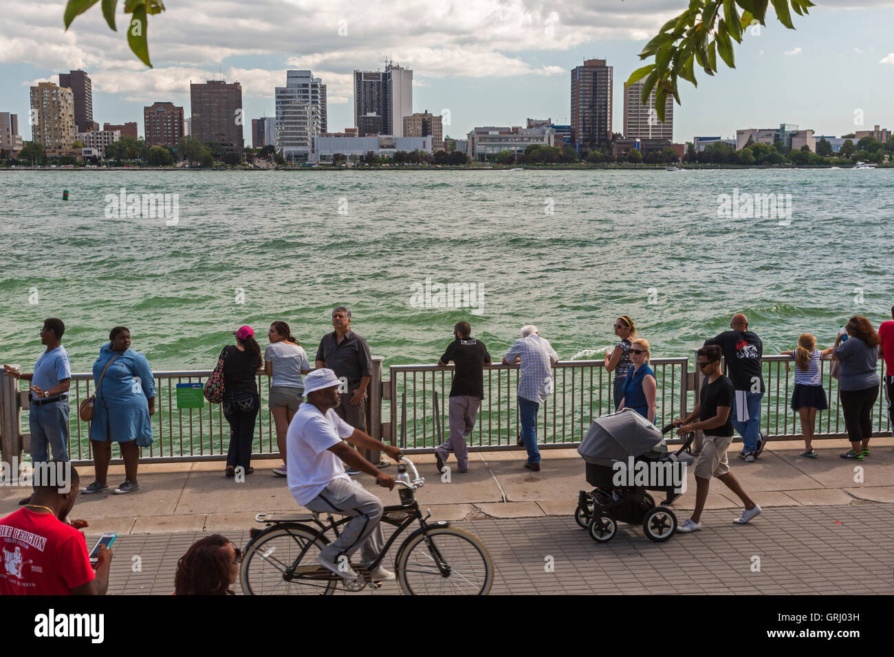 Detroit, Michigan - People on the Detroit Riverwalk on a Sunday afternoon. Windsor, Ontario is across the Detroit River. Stock Photo