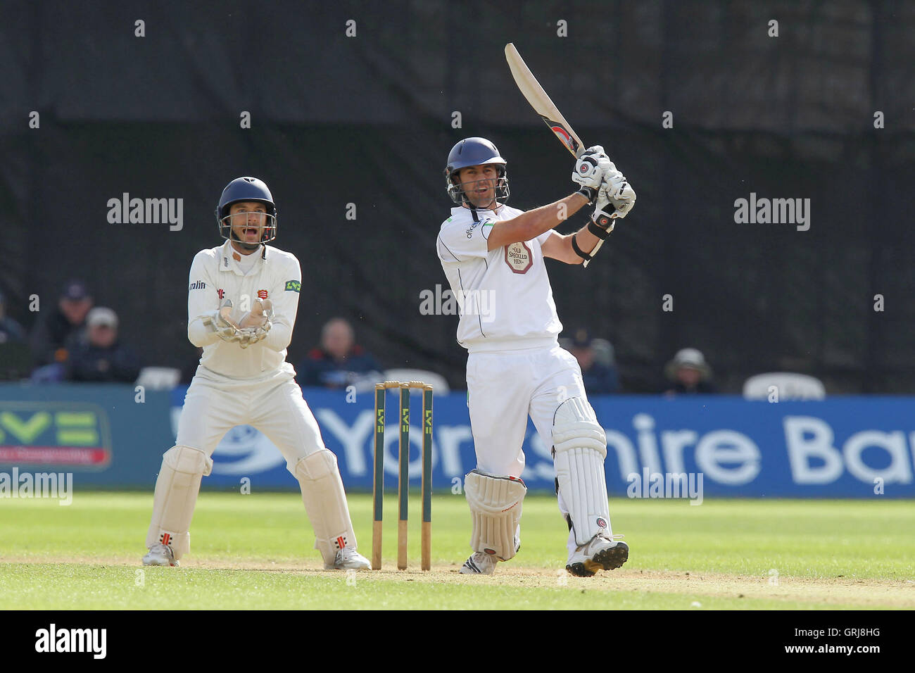 Tim Groenewald hits four runs for Derbyshire as James Foster looks on ...