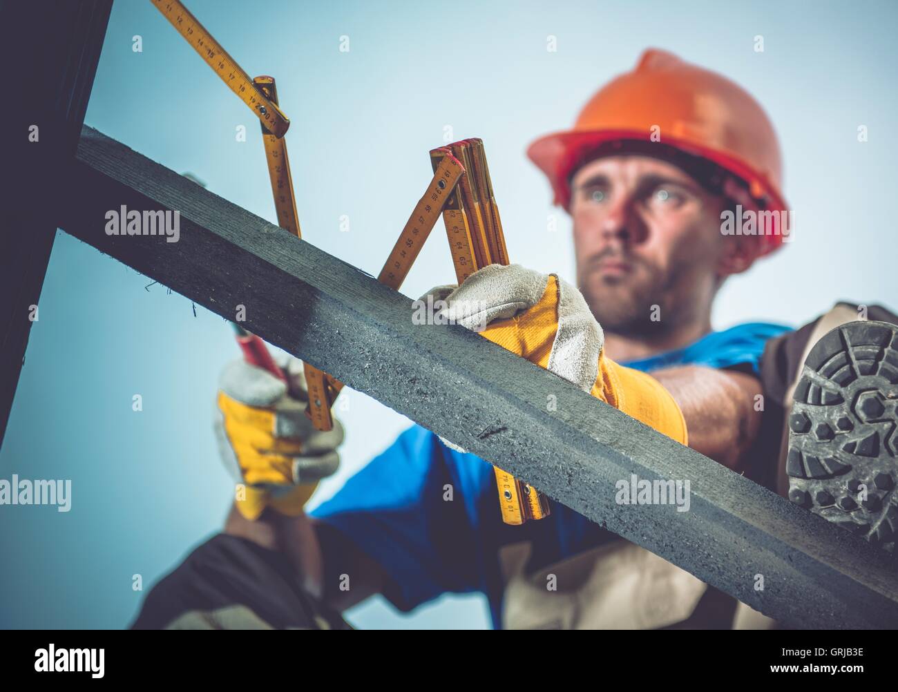 Construction Measuring Tool. Caucasian Wood Construction Worker with