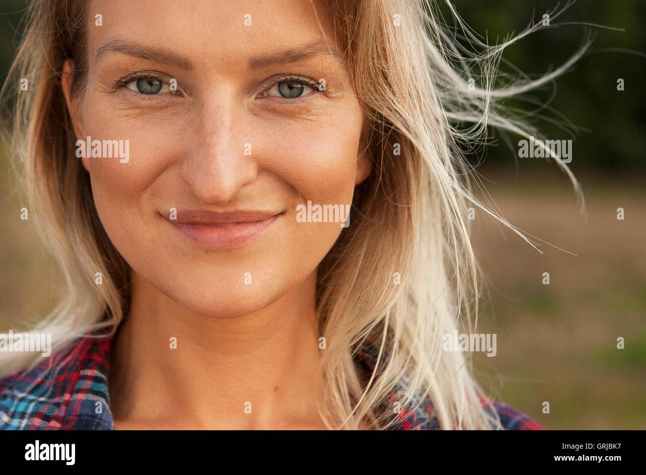 beautiful sunny portrait of a girl. Face smiling girl outdoors Stock Photo