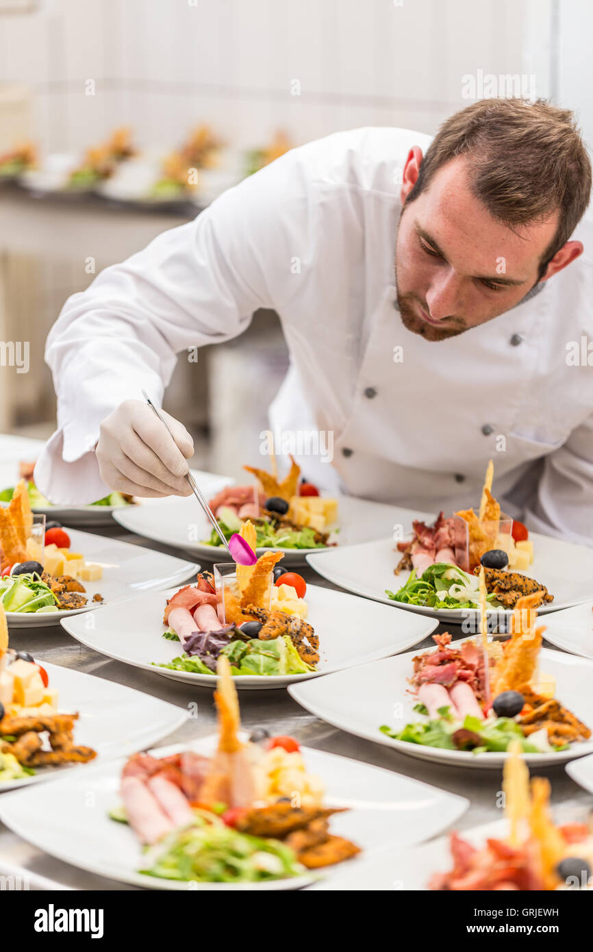 Chef is decorating delicious appetizer dish, fine dining restaurant Stock Photo