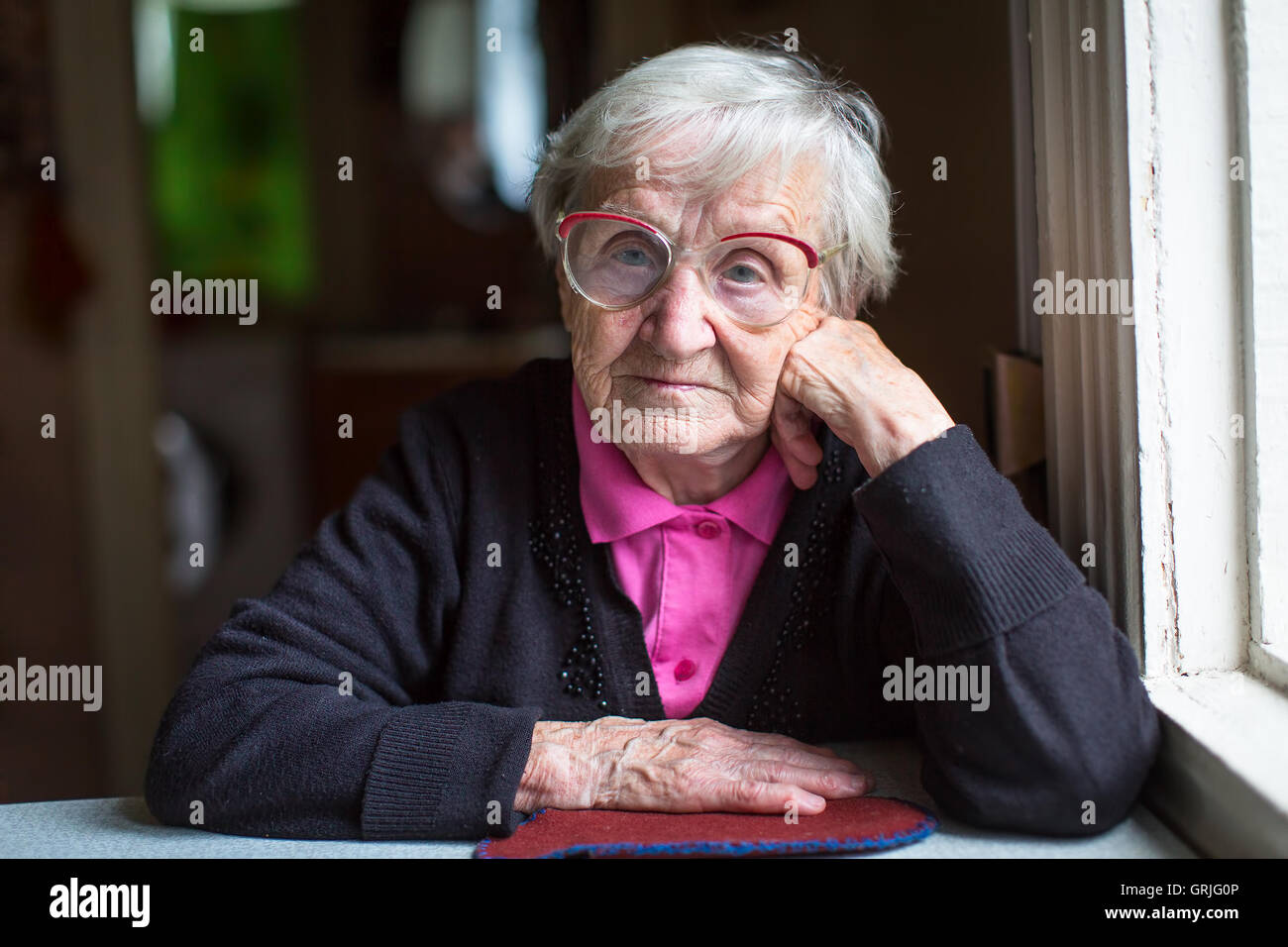 Old woman in profile sitting hi-res stock photography and images - Alamy