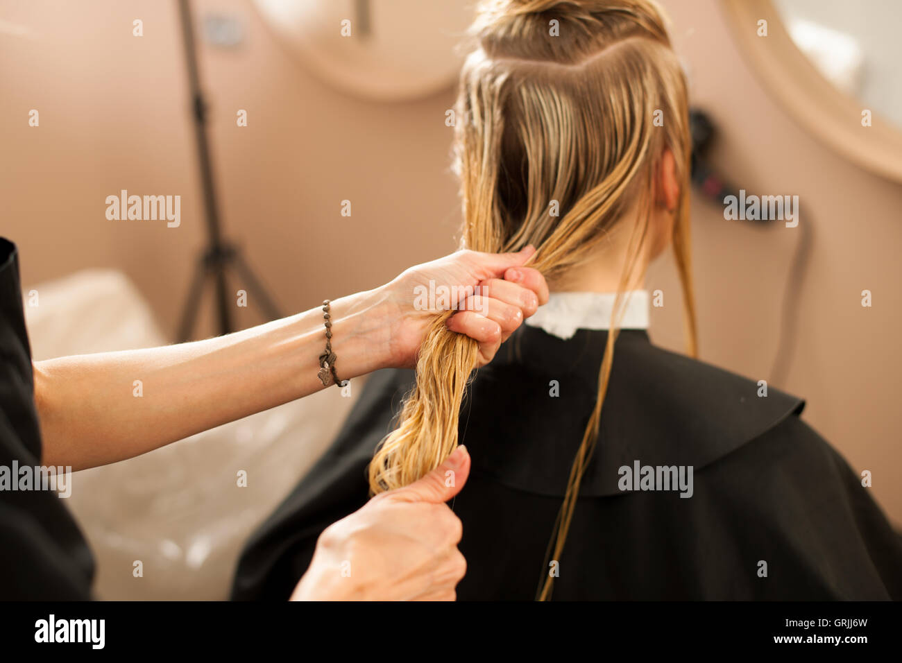 Hair stylist at work hairdresser cutting hair to the customer before doing hairstyle in a