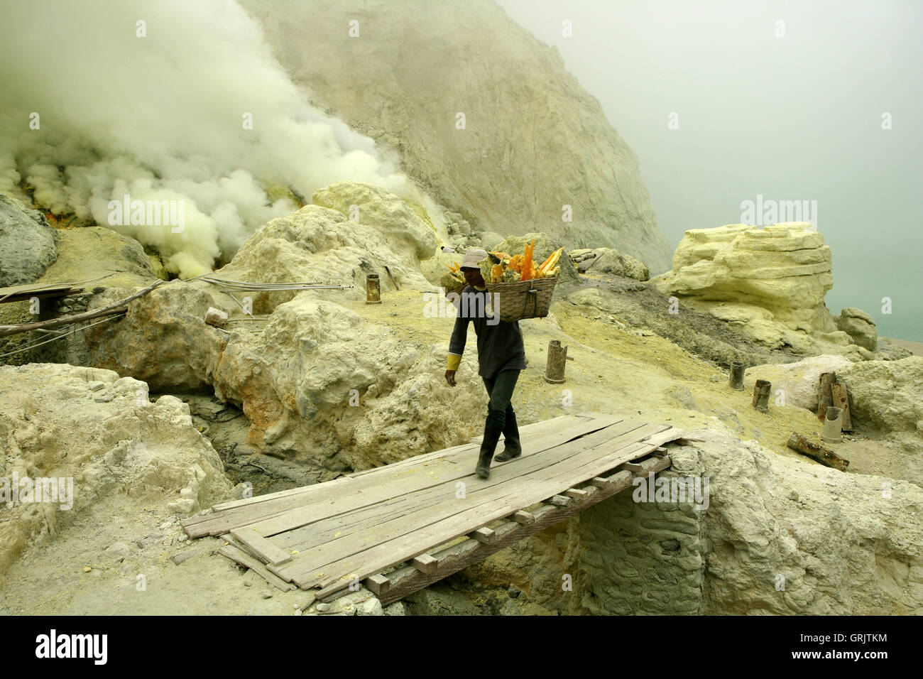 Sulfur miners mining sulfur at Ijen Volcano, Kawah ljen, eastern Java, Java, Indonesia Stock Photo