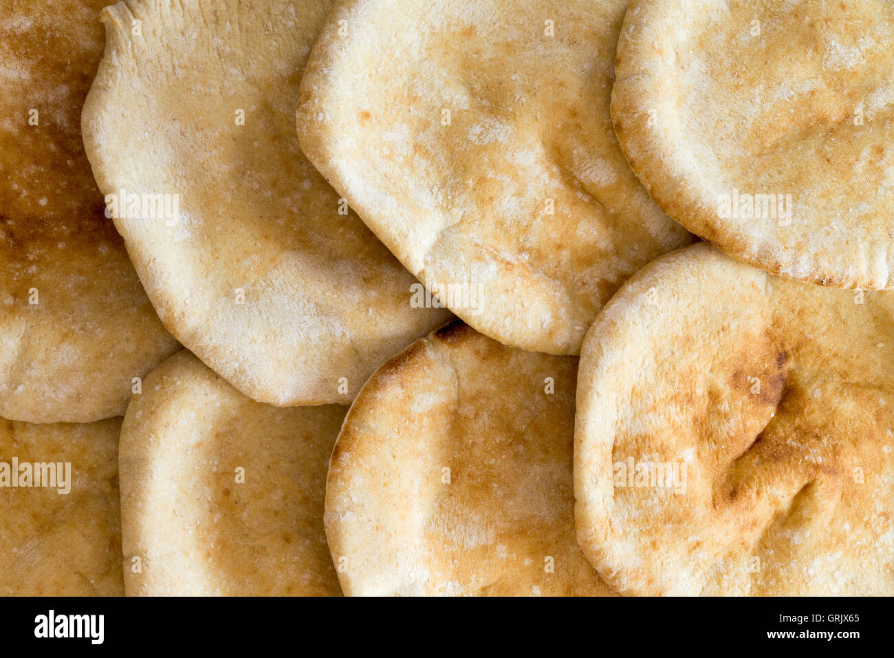 Background texture of freshly baked round pita breads arranged in an