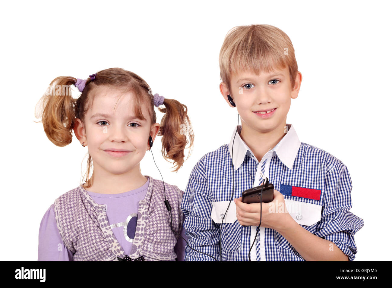 little girl and boy listening music on smart phone Stock Photo
