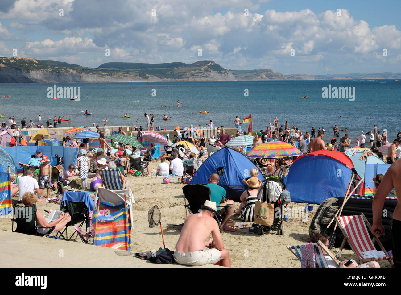 People in summer on the beach at Lyme Regis, Dorset, England UK  KATHY DEWITT Stock Photo
