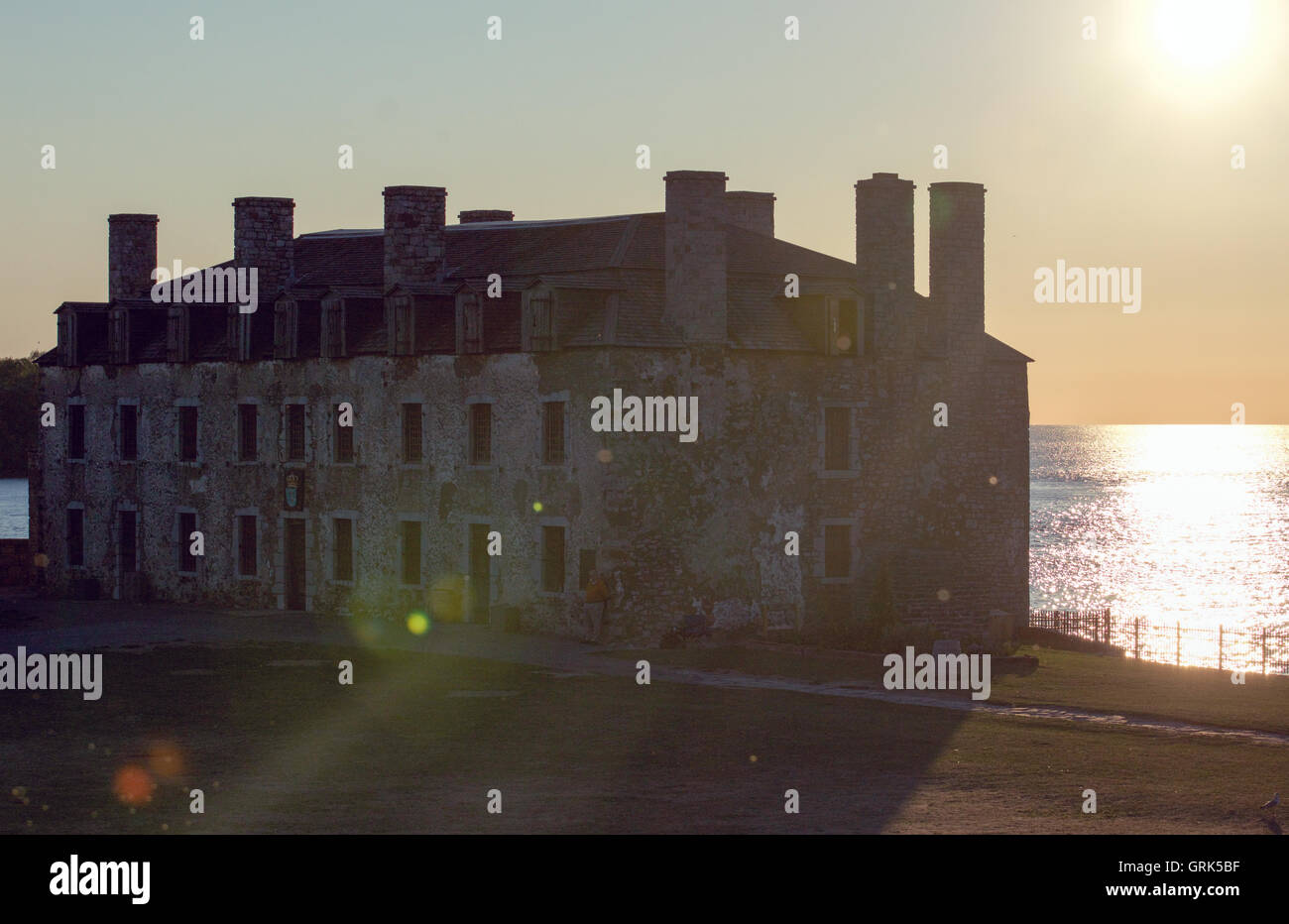 Sun flare behind the French fort at Fort Niagara, New York, on Lake Ontario at sunset. Stock Photo