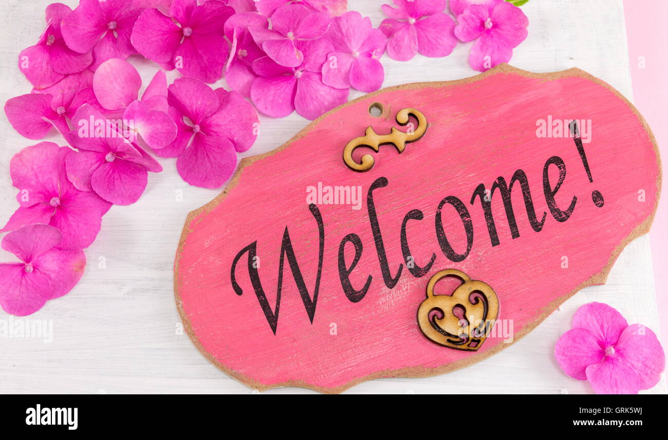 Welcome note written on the wooden frame Stock Photo