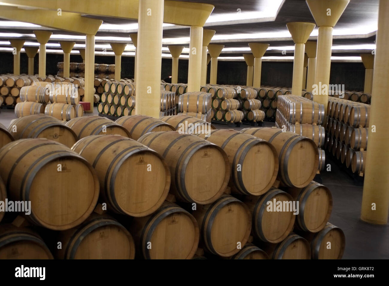 Casks of Rioja wine are stored in the cellar of a winery in Briones