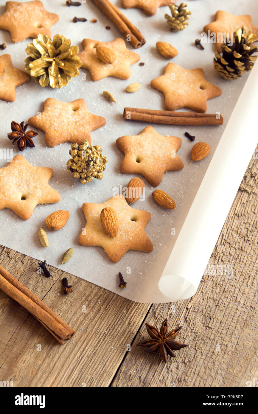 Christmas cookies and spices on baking paper - homemade winter bakery Stock Photo