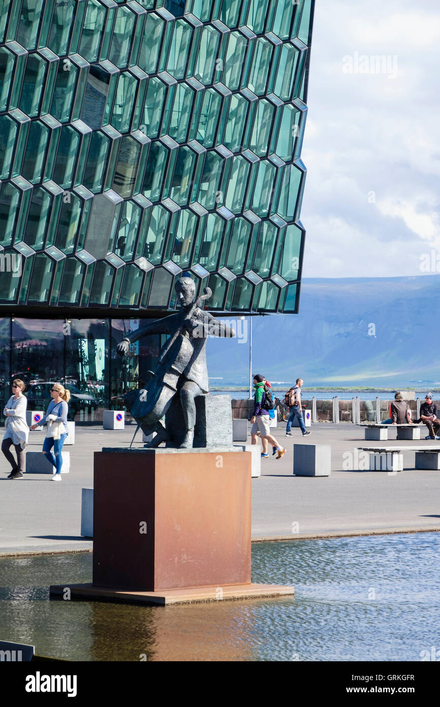 Musician sculpture outside Harpa concert hall and conference centre in modern glass building. Saebraut, Reykjavik, Iceland Stock Photo