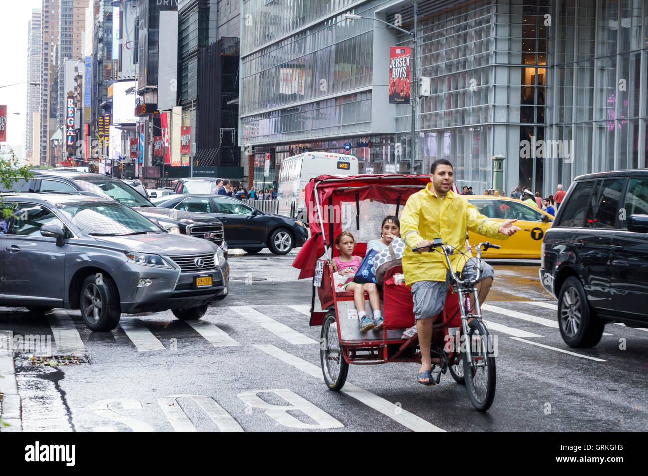 New York City,NY NYC Manhattan,Midtown,42 Street,traffic,intersection,car,pedicab,cycle rickshaw,adult,adults,man men male,woman female women,girl gir Stock Photo