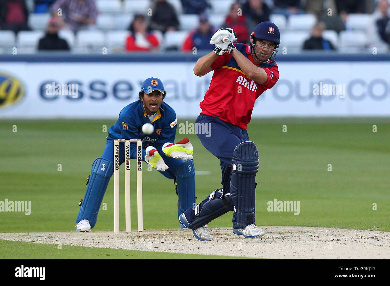 Alastair Cook of Essex hits out as Dinesh Chandimal of Sri Lanka looks on - Essex Eagles vs Sri Lanka - 50-over Tour Match at the Essex County Ground, Chelmsford - 13/05/14 Stock Photo