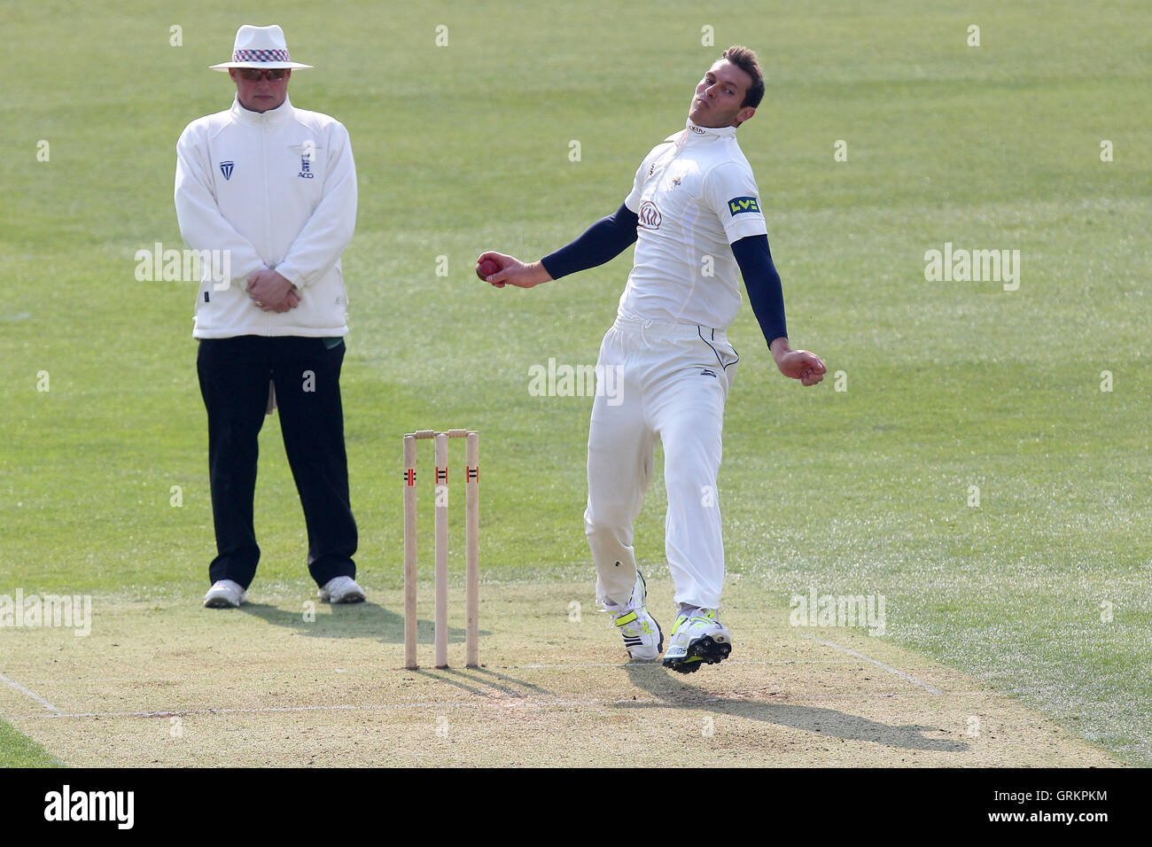 Chris Tremlett in bowling action for Surrey - Essex CCC vs Surrey CCC - Pre-Season Friendly Cricket Match at the Essex County Ground, Chelmsford - 27/03/14 Stock Photo