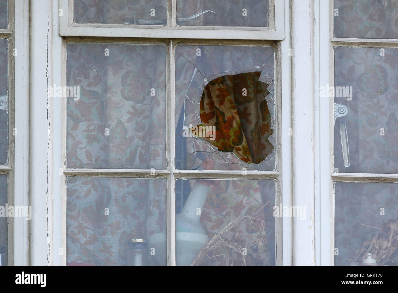 A window at the Hayes Close end of the ground is broken by a Ryan ten