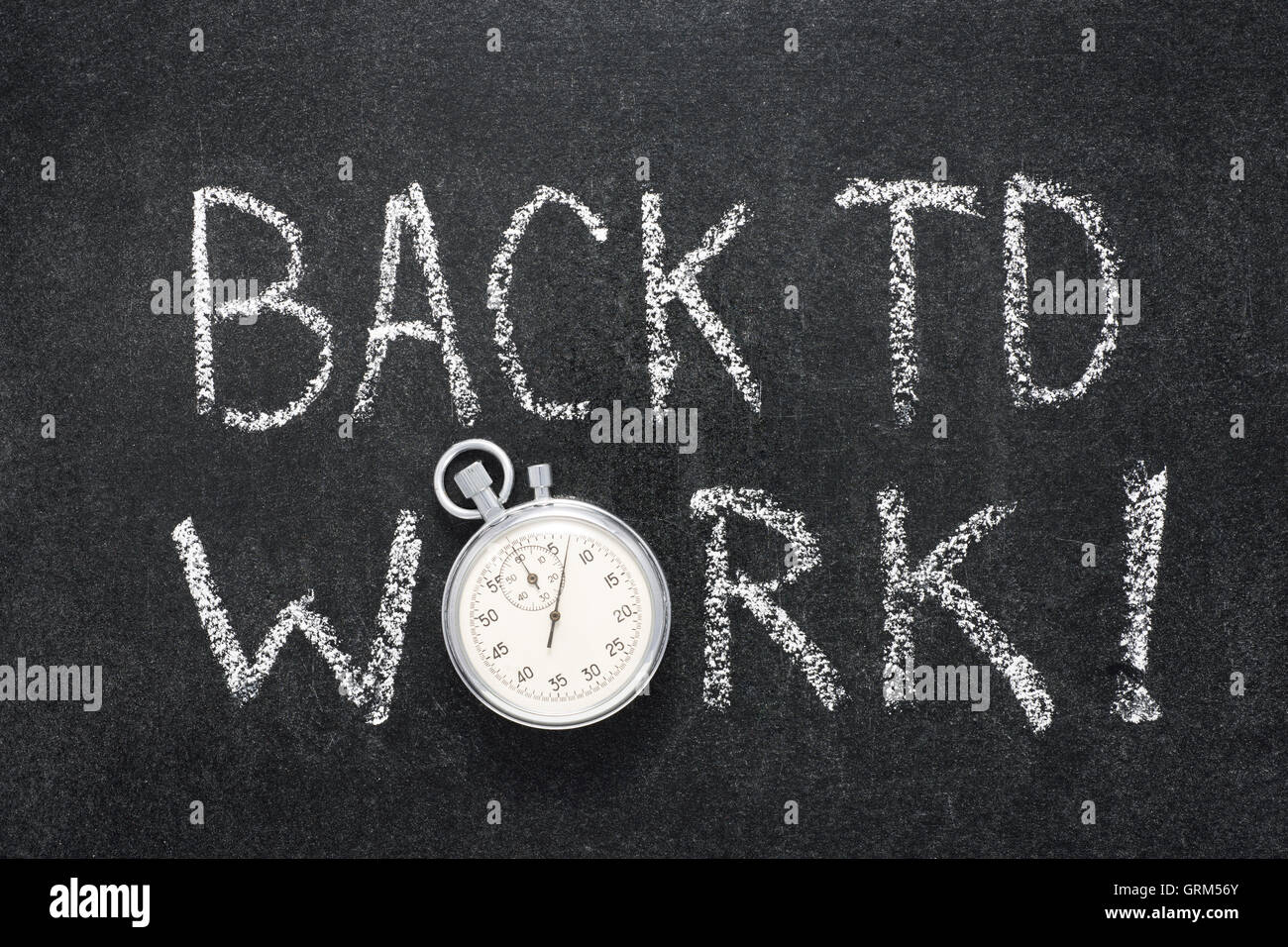back to work phrase handwritten on chalkboard with vintage precise stopwatch used instead of O Stock Photo