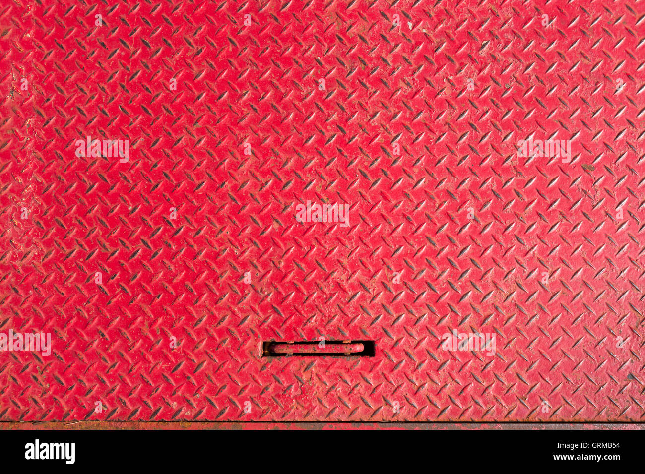 Red textured metal grate for background. Stock Photo