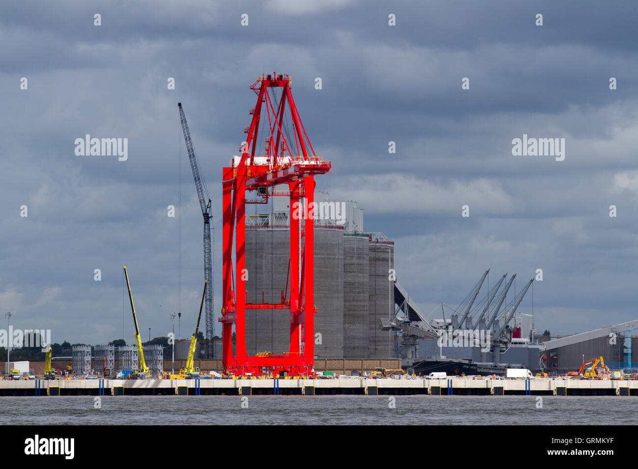 Operational cantilever rail-mounted gantry (CRMG) cranes; A single tall Megamax container unloading crane at Seaforth as seen from New Brighton, Wallasey, Liverpool, UK Stock Photo