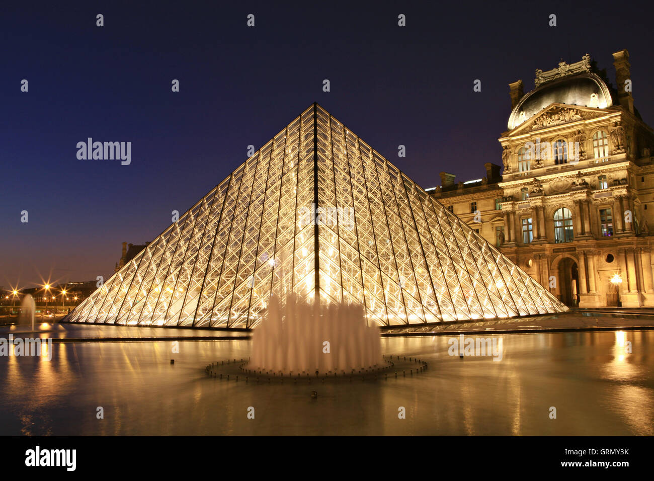 Paris, France - March 20,2013: Louvre museum at dusk on March 20, 2013 in Paris Stock Photo