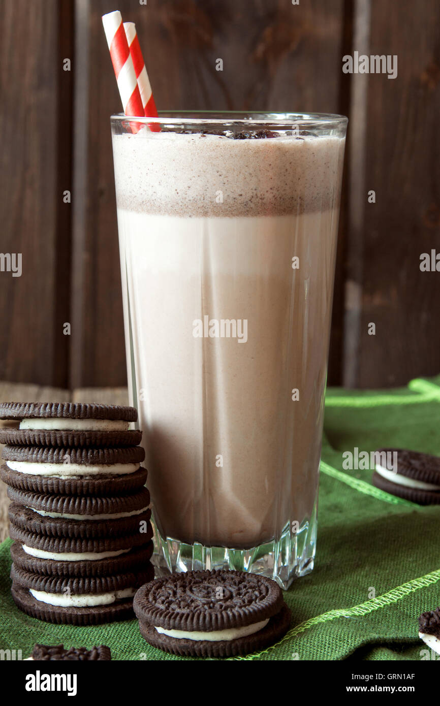 Homemade milkshake (chocolate smoothie) with cookies on rustic wooden table with copy space Stock Photo