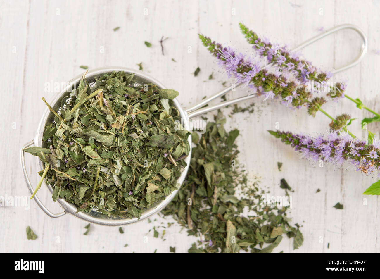 Mint tea herbs with flowers on a wooden table Stock Photo