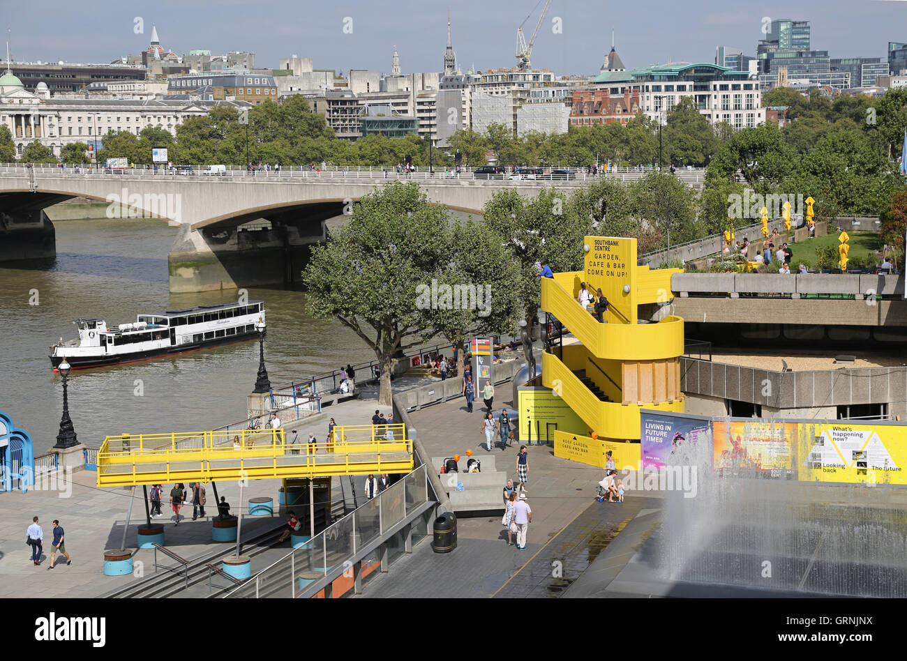 Riverside terraces on London's South Bank between the river Thames and the Royal Festival Hall. Waterloo Bridge beyond Stock Photo