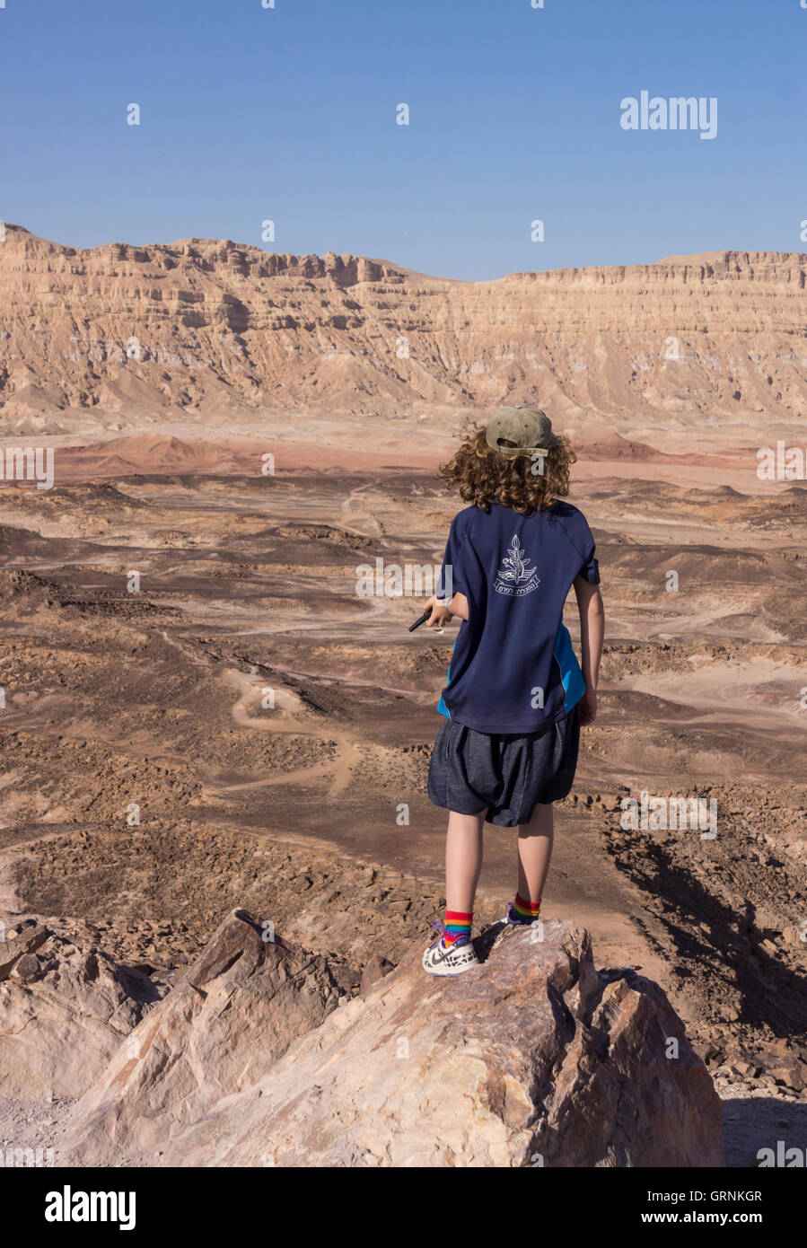 Ramon Crater, Israel. A girl hiking in the desert. Stock Photo