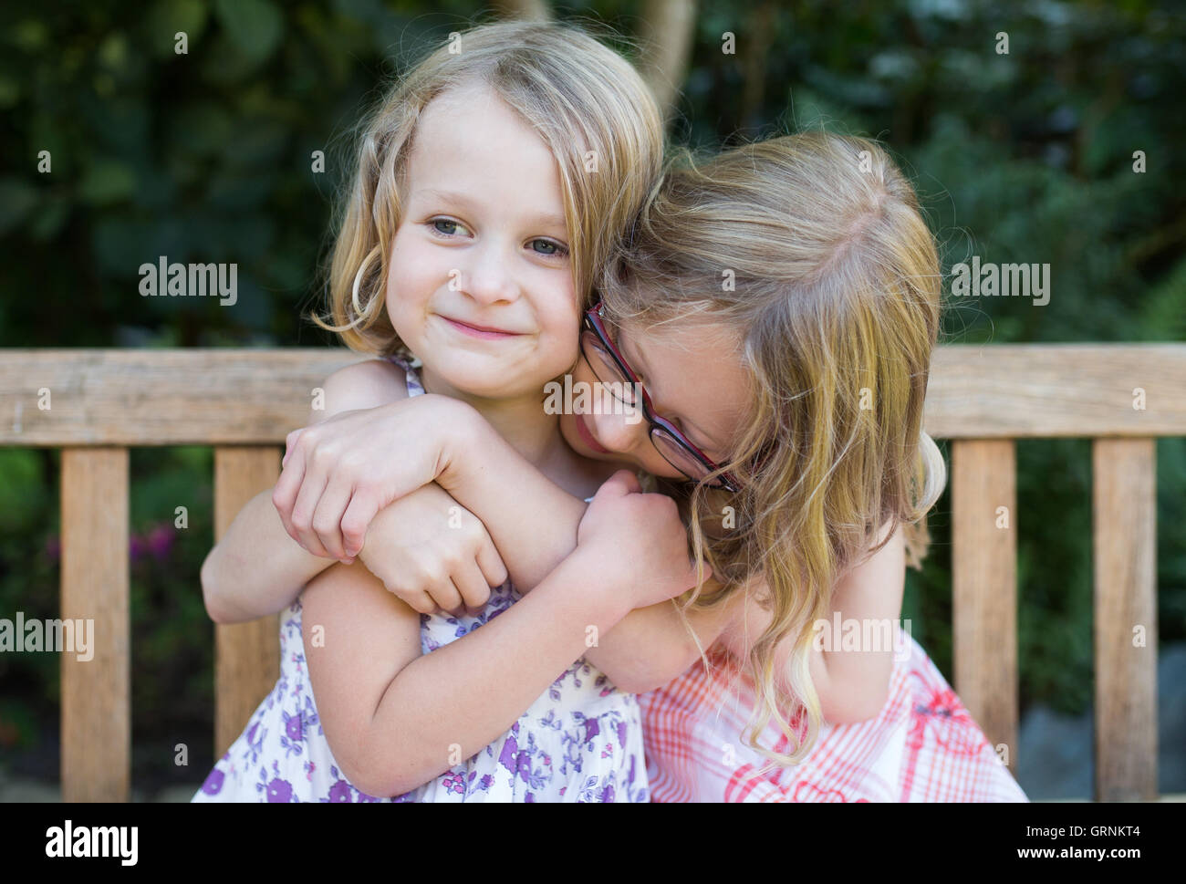 sisters cuddling and happy Stock Photo