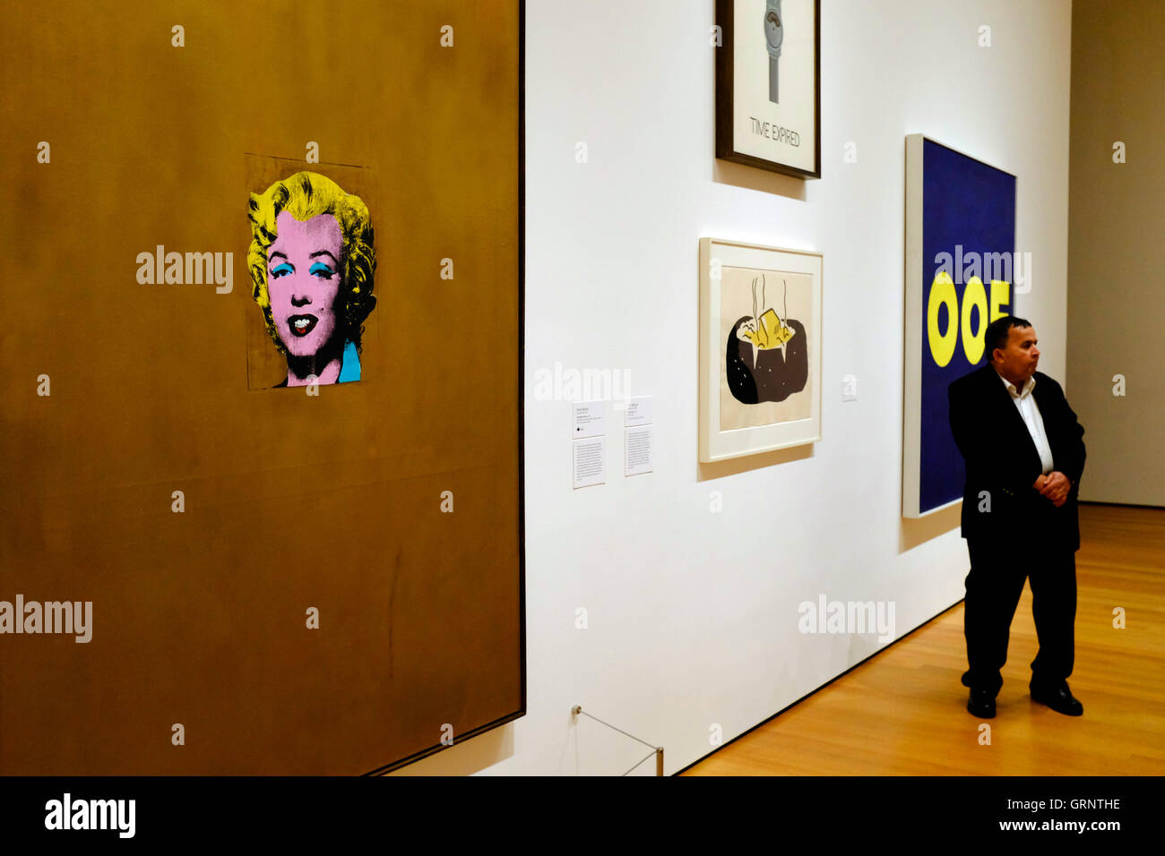 Visitor in front of Gold Marilyn Monroe by Andy Warhol at The Museum of Modern Art (MoMA).New York City,USA Stock Photo